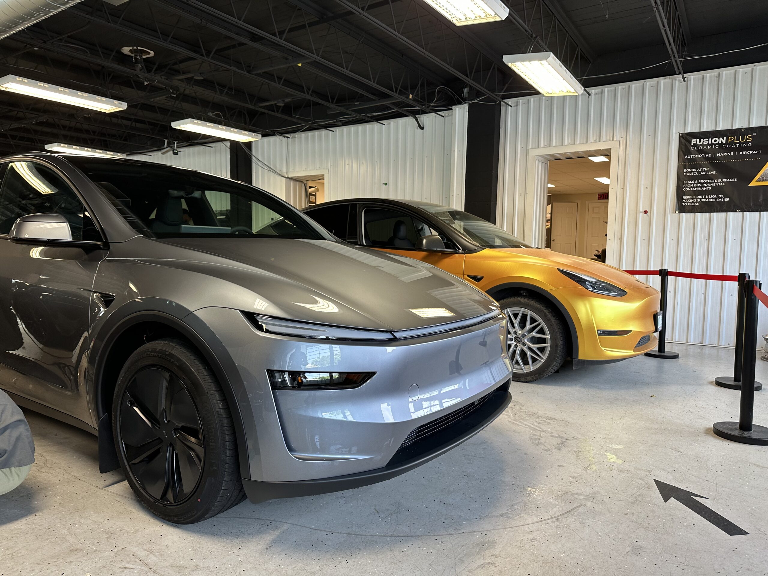 A Tesla receiving a premium full-body vinyl color change wrap at an Ottawa automotive customization studio.